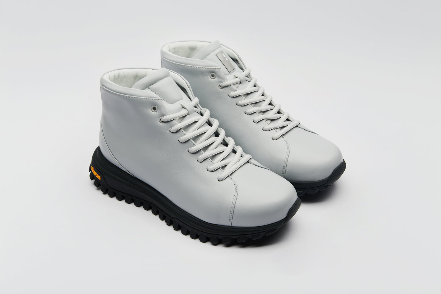 High-top sneaker with a rugged outsole and an elegant upper made from premium leather.