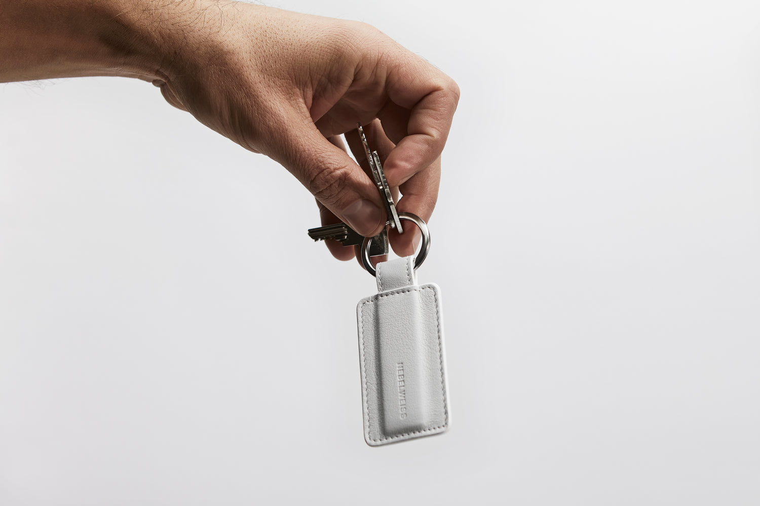 High quality leather key ring in a minimalistic yet elegant shade of white.