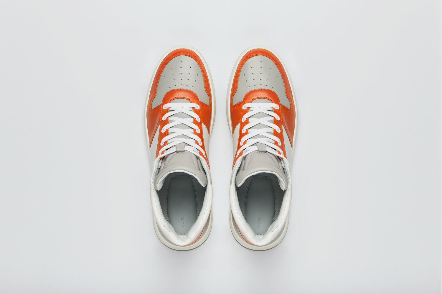 Elegant orange and grey luxury sneaker, with a calfskin lining.